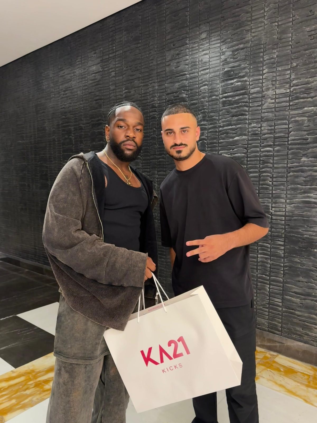Kevin Aoun with Tayc holding a KA21 Kicks bag